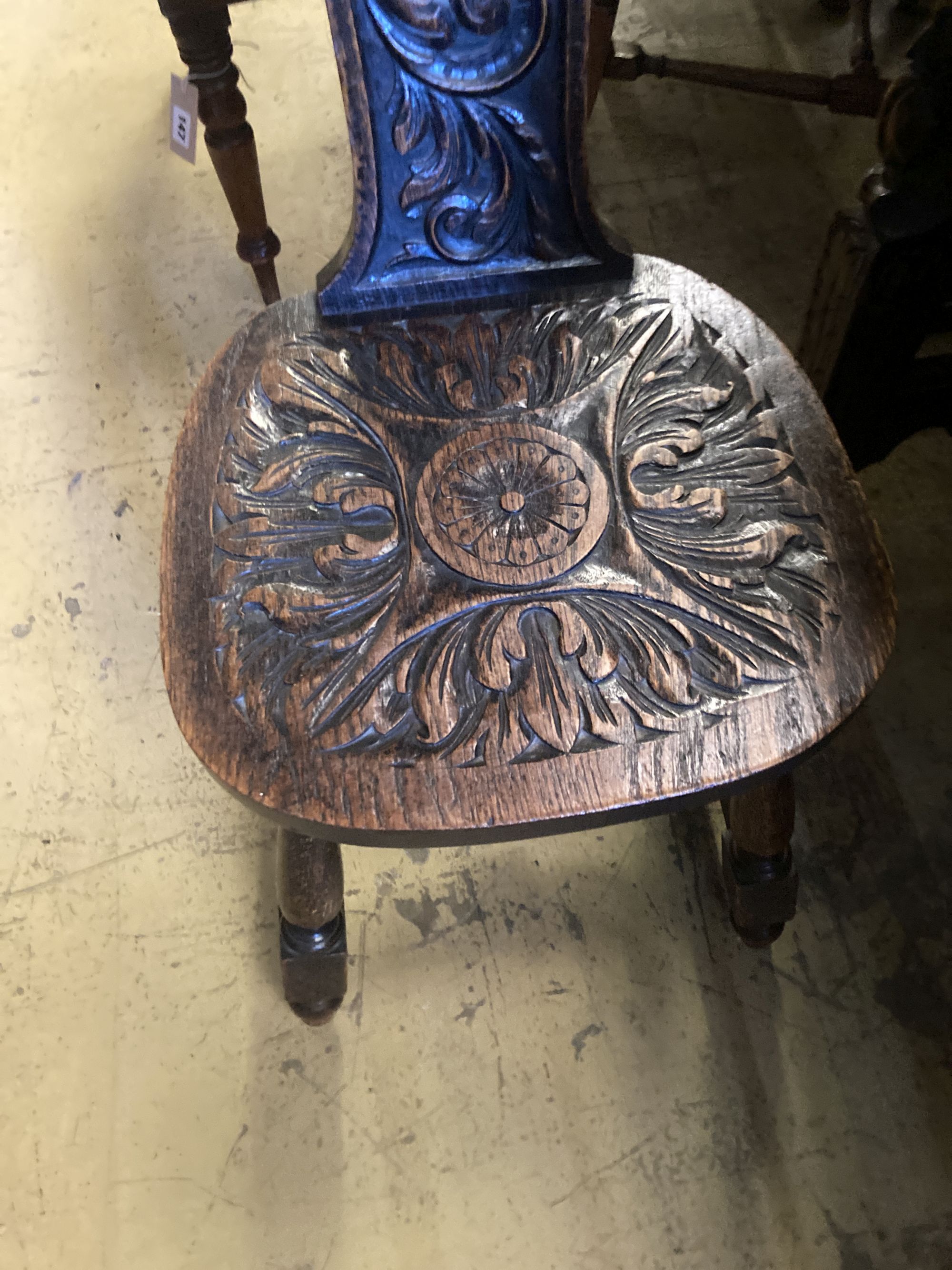 A late 19th century Flemish carved oak side table, width 88cm, depth 42cm, height 76cm, together with a carved oak spinning chair